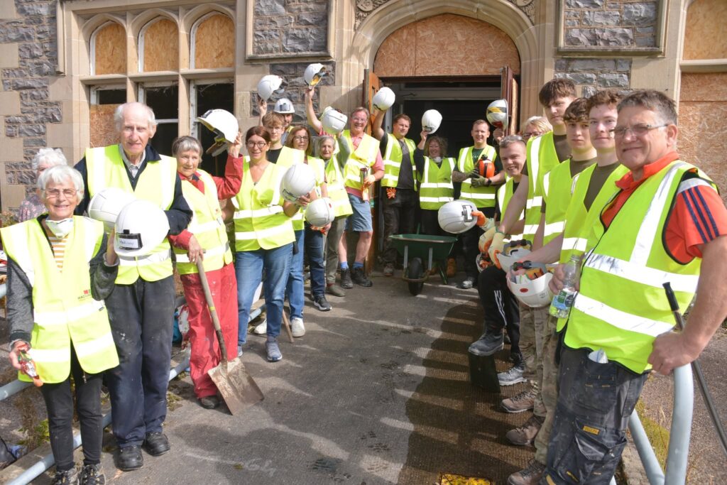 Volunteers in hi-vis at the door of Leanchoil, August 2026